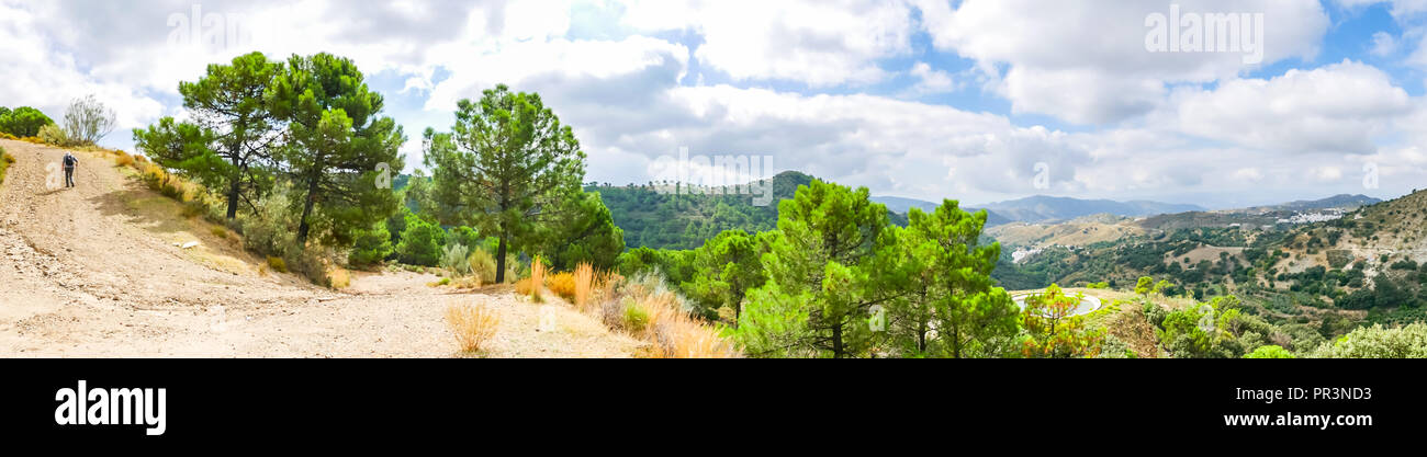 Panorama view of GR mountain walking route 249 with man walking on track, Sierras de Tejeda Natural Park, Salares, Axarquia, Andalucia, Spain Stock Photo