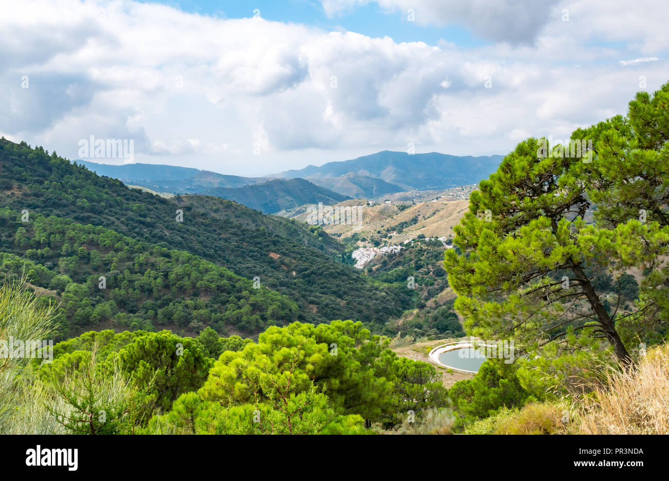 GR mountain walking route 249 with valley and water reservoir for fire fighting, Sierras de Tejeda Natural Park, Salares, Axarquia, Andalucia, Spain Stock Photo