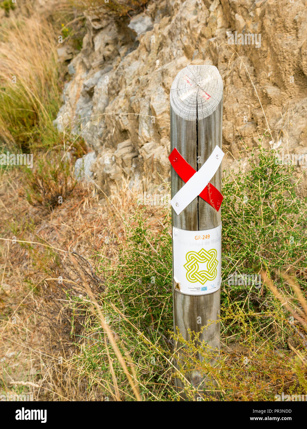 Mountain walking route with wrong way wooden marker post, Sierras de Tejeda Natural Park, Axarquia, Andalucia, Spain Stock Photo