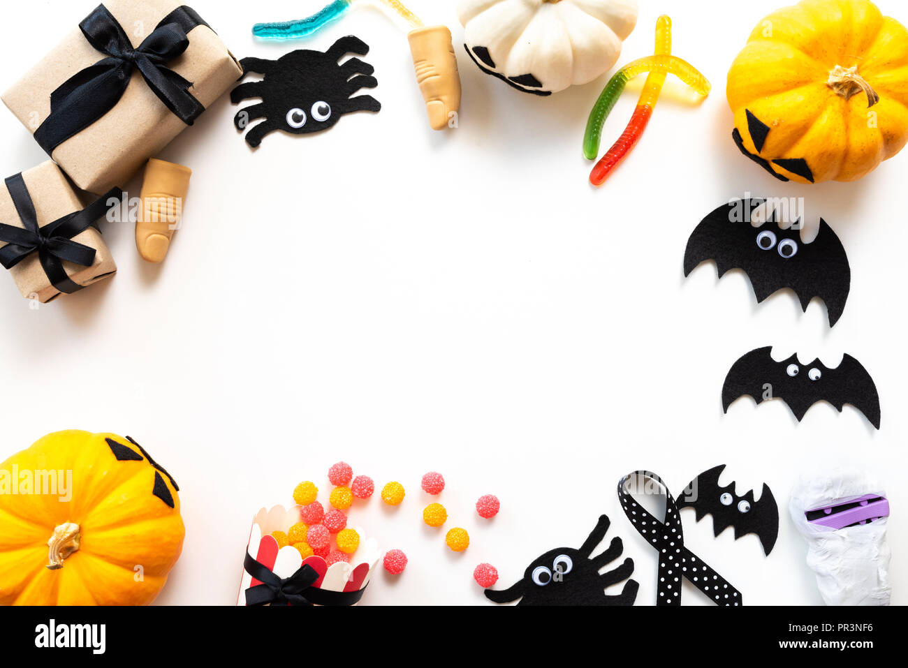 Top view of white and yellow ghost pumpkins with bat, spider, mummy ...