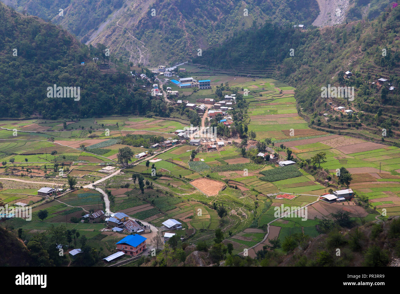 A small remote village surrounded by mountains in a rural area Stock Photo