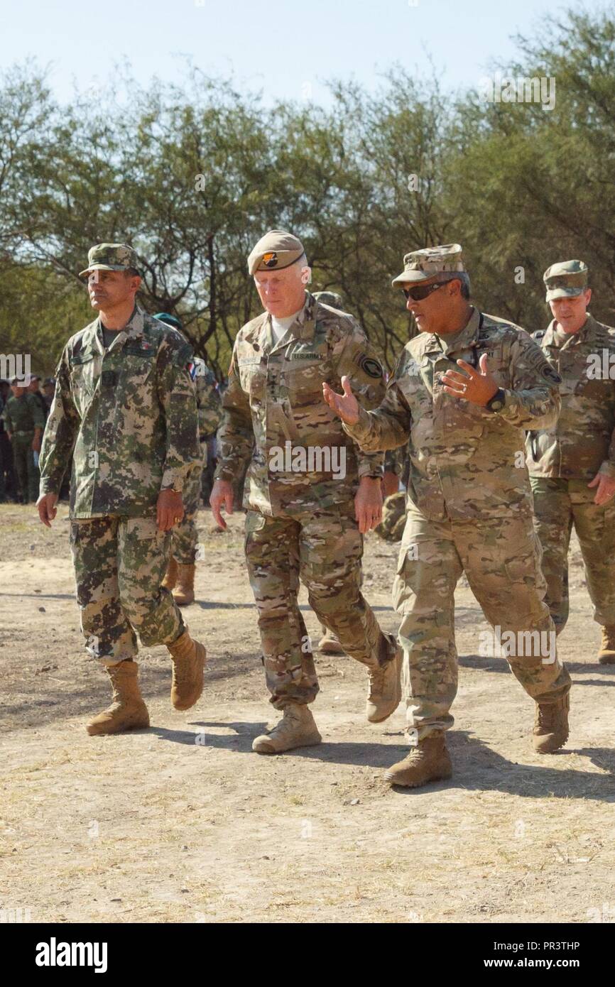 U.S. Special Operations Command Commander, Army Gen. Raymond A. Thomas III (center), receives a Fuerzas Comando overview from the competition’s Paraguayan and U.S. directors July 24, 2017, in Vista Alegre, Paraguay. Paraguayan army Brig. Gen. Hector Limenza (left) and U.S. Army Lt. Col. Angel Martinez (3rd from left) joined Thomas as he observed events and visited multinational Special Operations Forces. Stock Photo