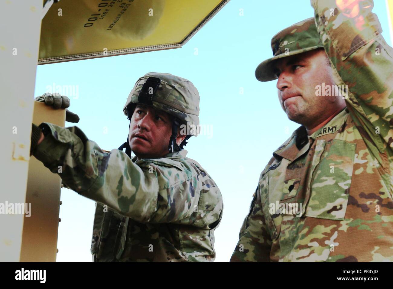 Army Sgt. Marco Zapiain (left), a Soldier in the Florida National Guard's 3rd Battalion, 265th Air Defense Artillery Regiment, helps a fellow Soldier from the California National Guard calibrate the radar tracking system during Operation Northern Strike at Camp Grayling, July 30, 2017. Operation Northern Strike is a two-week exercise that assesses the working knowledge of air-to-ground forces between the U.S.Army, Air Force and Marine units from around the country, as well as, Latvian, Great Britain, and Polish military personnel. Stock Photo