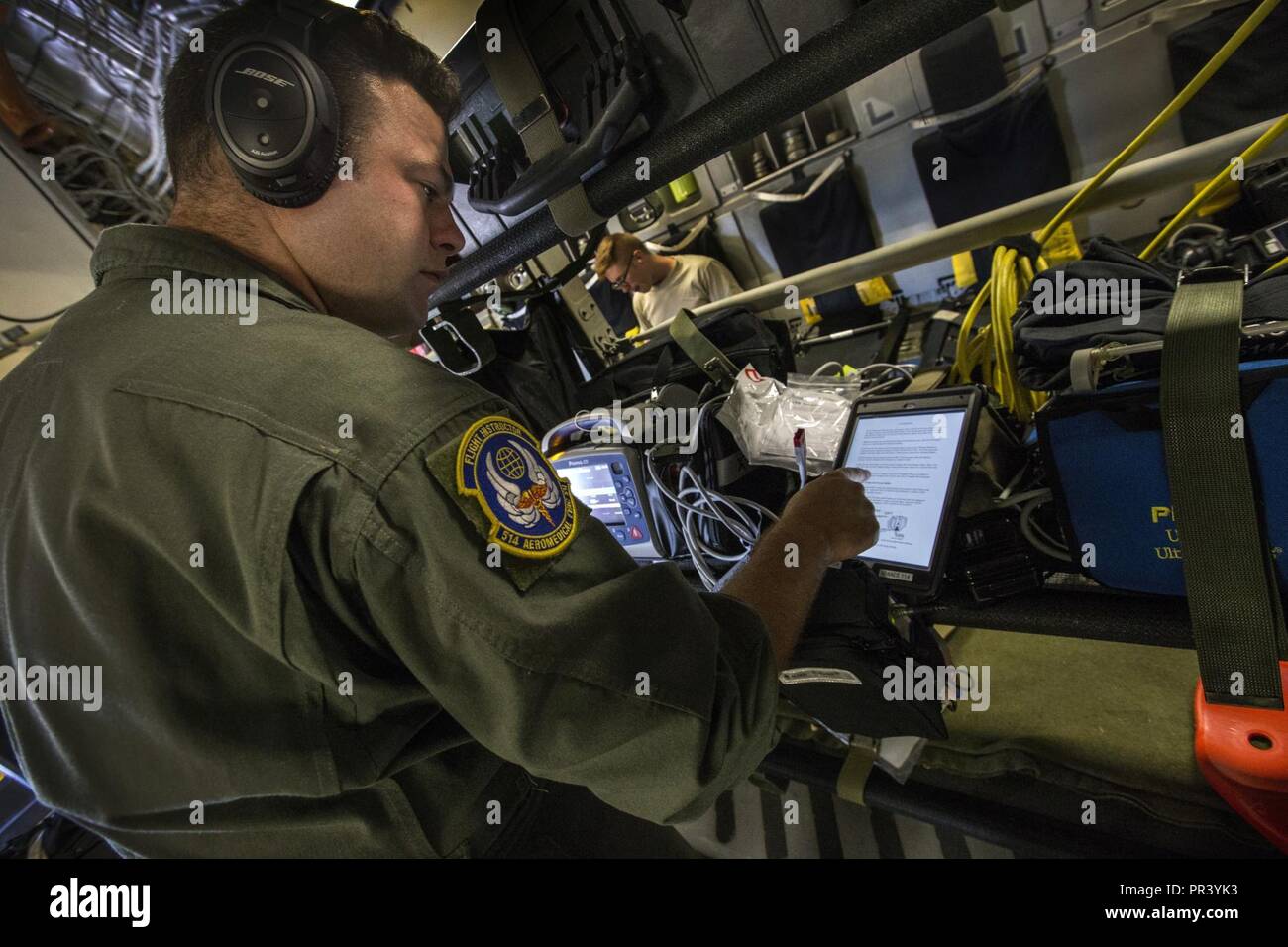 U.S. Air Force Master Sgt. Garrett T. Hilliker, aeromedical evacuation flight instructor, 514th Aeromedical Evacuation Squadron, 514th Air Mobility Wing, performs a systems check on a vital signs monitor during an aeromedical evacuation training mission onboard a 305th Air Mobility Wing C-17 Globemaster III from Nashville, Tenn., to Joint Base McGuire-Dix-Lakehurst, N.J., July 30, 2017. The mission, which ran from July 29-30, was to teach flight nurses and aeromedical evacuation technicians how to respond to both medical and aircraft emergencies while evacuating sick or wounded personnel from  Stock Photo