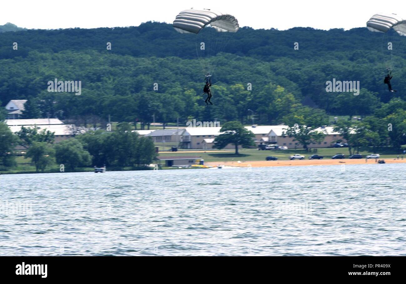 Two Marines from Echo Company, 4th Reconnaissance (Recon) Battalion out of Joliet, Illinois land in Camp Grayling's Lake Margrethe after jumping from a CH-47 Chinook helicopter at 1500 ft elevation. 4th Recon Marines conduct operations as part of Northern Strike 17. Northern Strike 17 is a National Guard Bureau-sponsored exercise uniting approximately 5,000 service members from 13 states and five coalition countries during the first two weeks of August 2017 at Camp Grayling Joint Maneuver Training Center and the Alpena Combat Readiness Training Center, both located in northern Michigan and ope Stock Photo