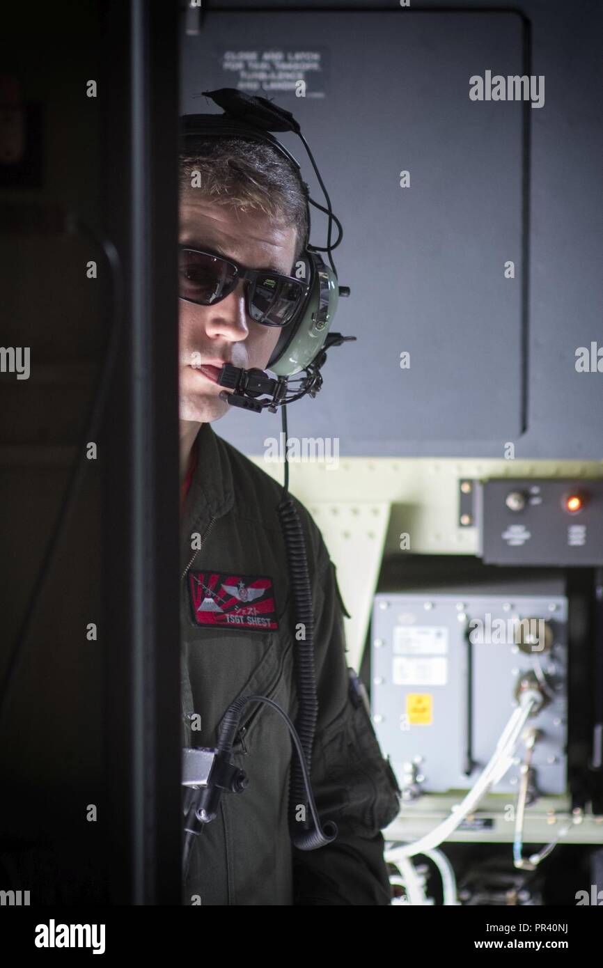 Tech. Sgt. Benjamin Shest, 36th Airlift Squadron C-130J loadmaster, communicates with crew members at Yokota Air Base, Japan, July 28, 2017, during a training mission. This mission helped the loadmasters with the 36th AS maintain their airlift techniques to be ready to keep the mission going. Stock Photo