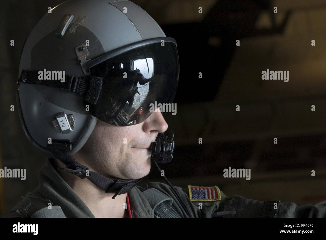 Tech. Sgt. Benjamin Shest, 36th Airlift Squadron C-130J loadmaster, observes a survival, evasion, resistance and escape specialist assigned to the 374th Operations Support Squadron perform his checks before executing a static line jump training over Yokota Air Base, Japan, July 28, 2017. This mission helped the loadmasters with the 36th AS maintain their airlift techniques to be ready to keep the mission going. Stock Photo