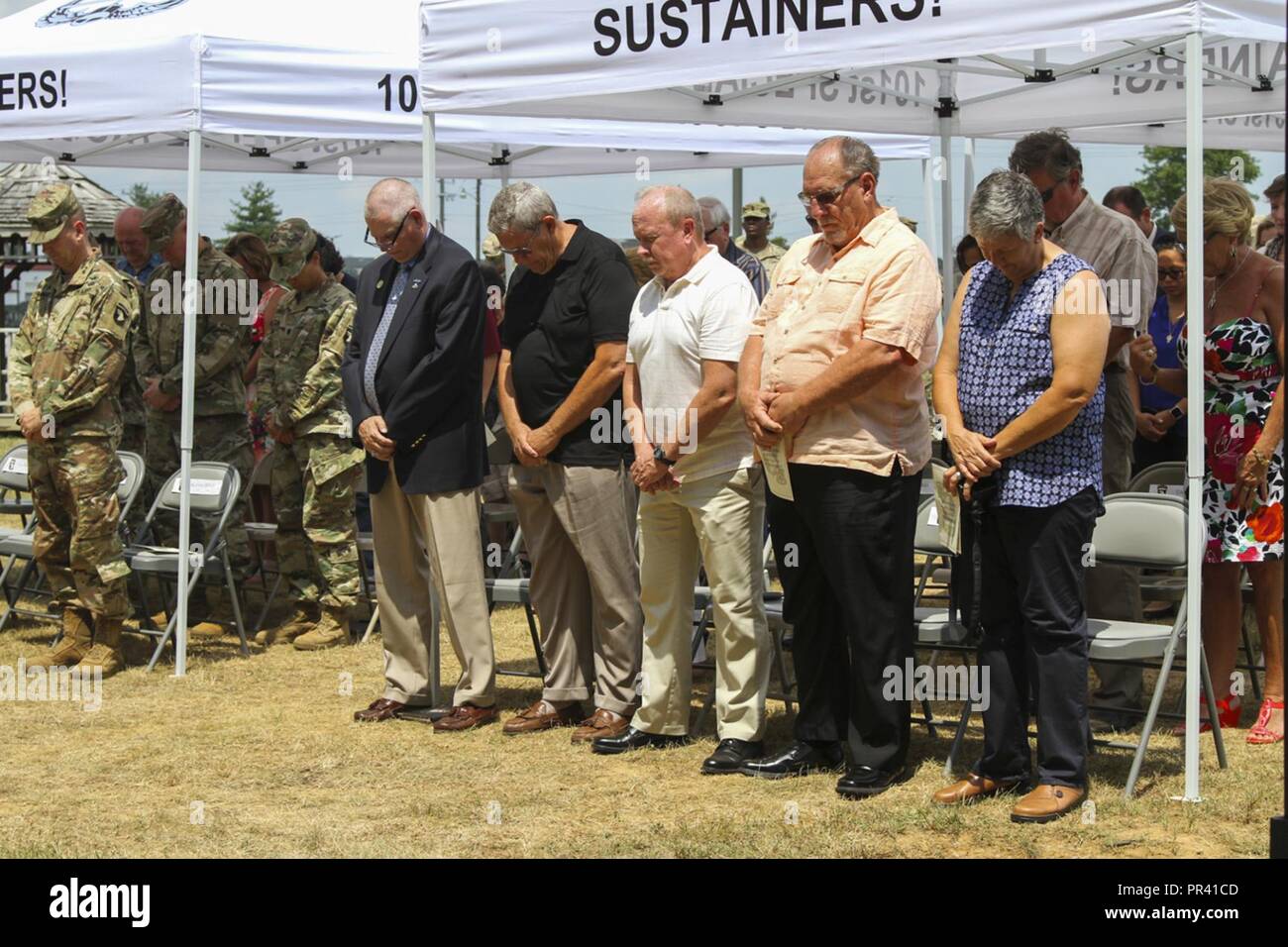 Veterans of the Fort Campbell finance team bow their heads for a moment