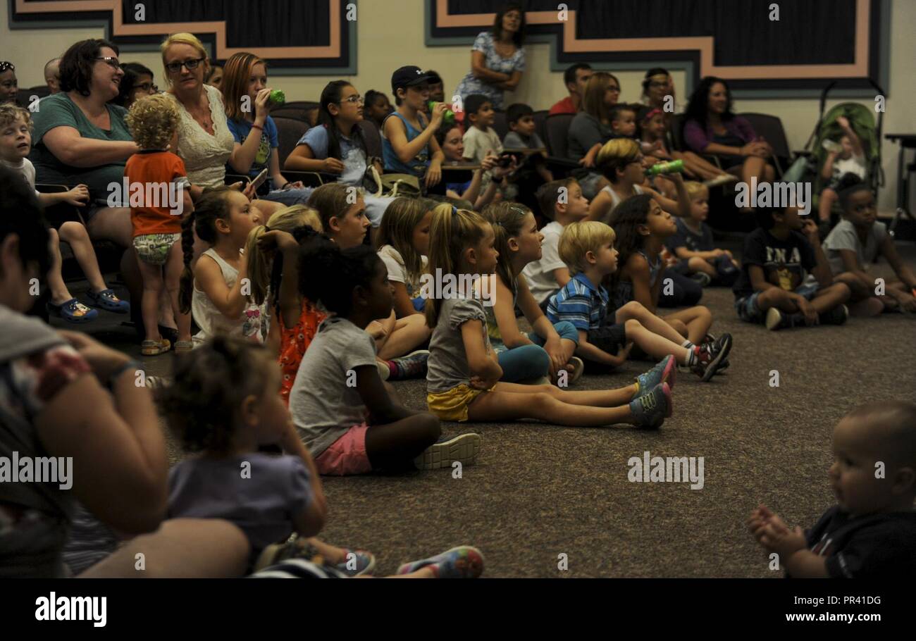 A group of Team Hurlburt youth watch an animal specialist give a presentation at Hurlburt Field, Fla., July 27, 2017. The animal exhibit presentation was part of the Hurlburt Field Library’s Summer Reading Program, a program designed to encourage young people to read over the summer months. The animal exhibit introduced kids to exotic wildlife such as a coastal carpet python, an African spurred tortoise and a black-tailed prairie dog. Stock Photo