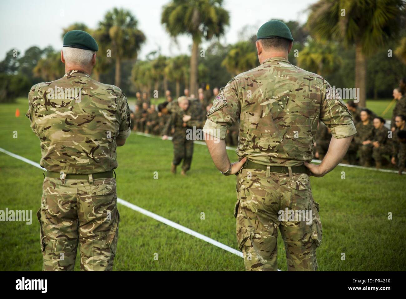 British Royal Marine Commandos watch as a U.S. Marine Corps drill  instructor demonstrates the maneuver-under-fire portion of a Combat Fitness  Test to the recruits of Oscar Company, 4th Recruit Training Battalion, July