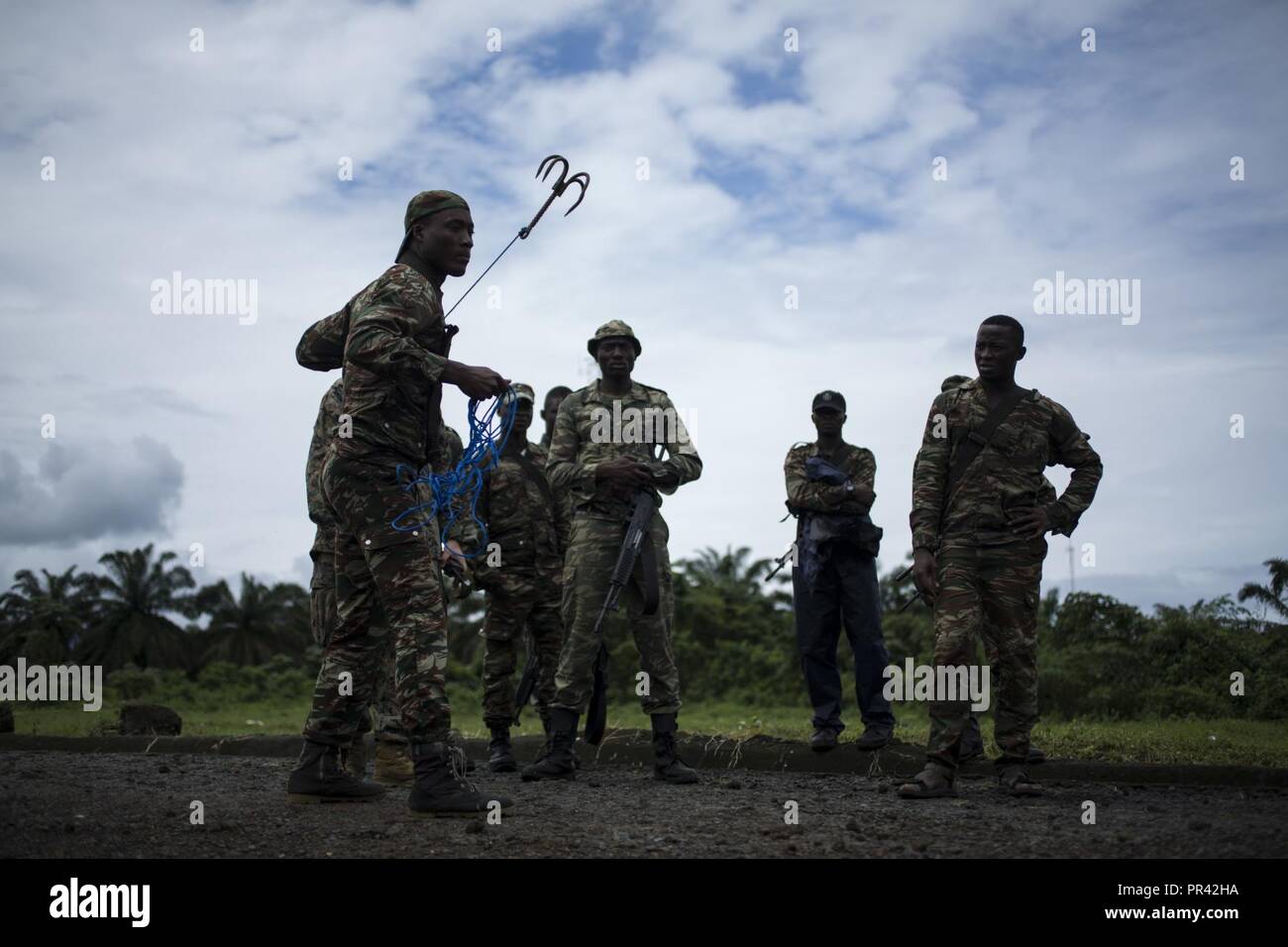 A Cameroonian Marine prepares to throw a grappling hook while training with  combat engineers assigned to Special Purpose Marine Air-Ground Task  Force-Crisis Response-Africa near Limbe, Cameroon, July 25, 2017.  SPMAGTF-CR-AF deployed to