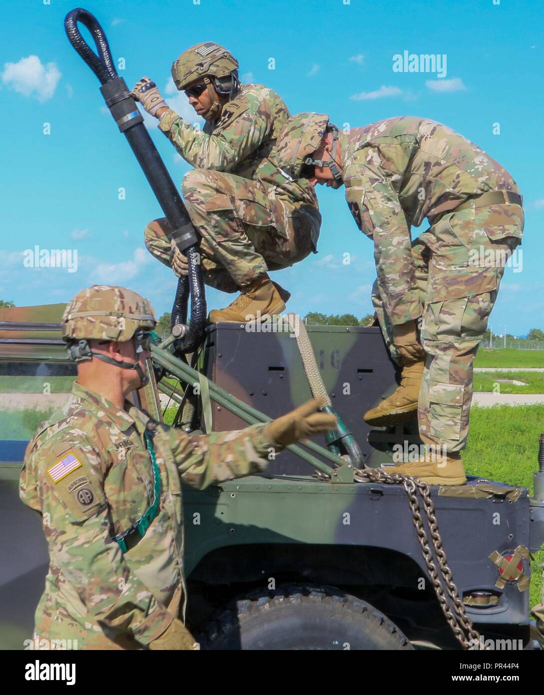 11th ENG 2CAB Soldiers wait for chinook to come close enough to hook up the tactical vehicle.  They are conducting sling load training at Camp Humphteys, South Korea Stock Photo