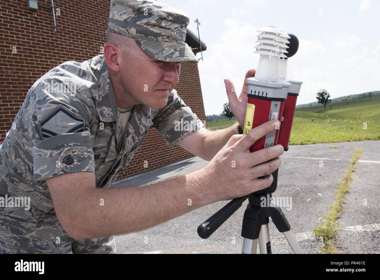 Master Sgt. Gary Fletcher, 167th Airlift Wing bioenvironmental engineering superintendent, checks a wet bulb globe thermometer outside of his office, Sep. 5, 2018, at the Martinsburg, W.Va. air base as part of the unit’s thermal injury prevention program. The thermometer reading of 92 F, warranted black flag conditions and recommendations for work to rest cycles for those working outside. The bioenvironmental engineering office monitors the temperature throughout the day when temperatures are expected to reach at least 85 degrees Fahrenheit. They announce green, yellow, red or black flag condi Stock Photo