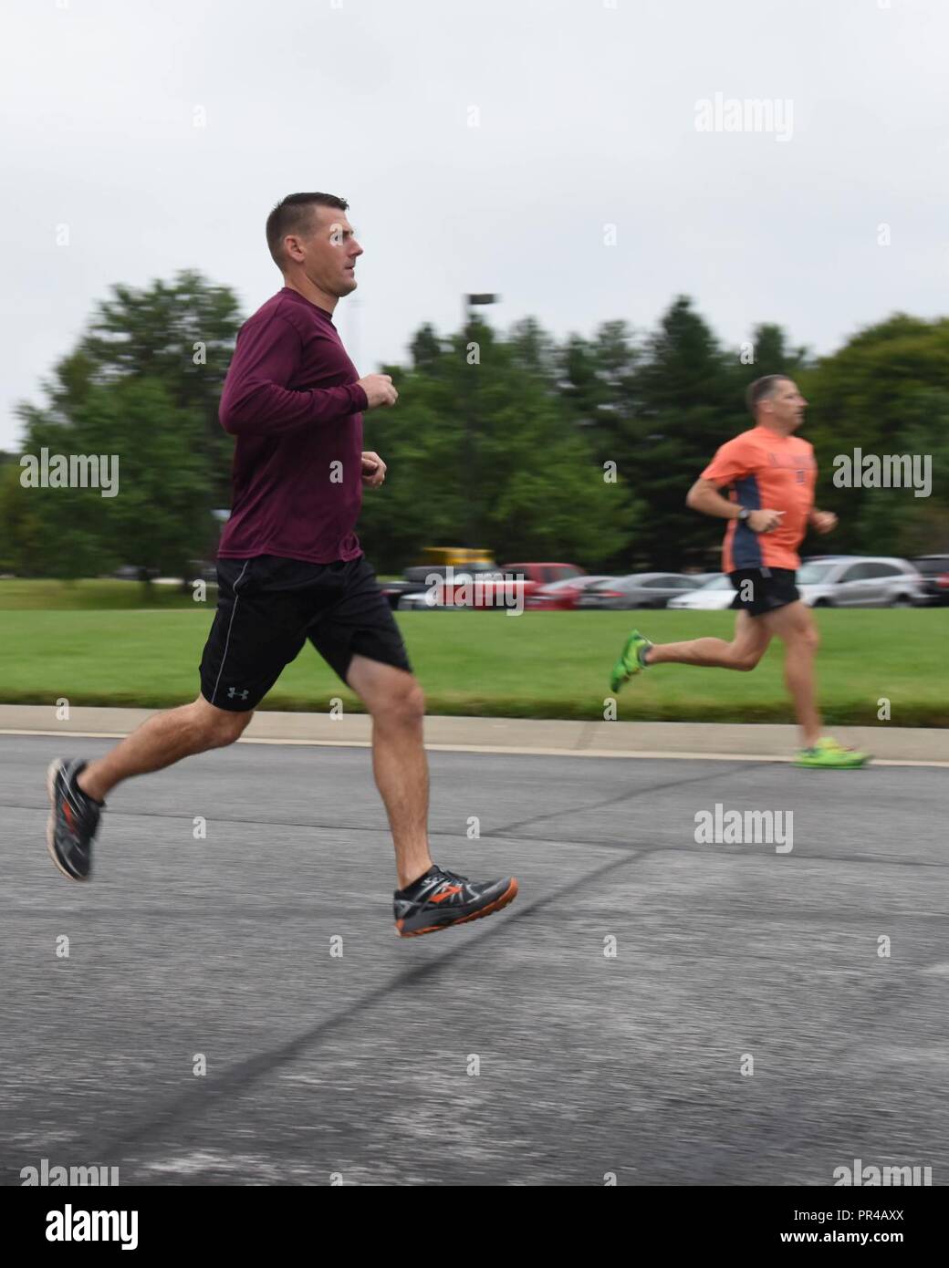 (from left) Senior Master Sgt. Christopher Mertz, 126th Air Refueling Wing first sergeant, and Col. Thomas Jackson, 126th Operations Group commander, participate in a 3K run Sept. 9, 2018, at Scott Air Force Base, Ill. The wing hosted the run in honor of Suicide Prevention Month. Stock Photo