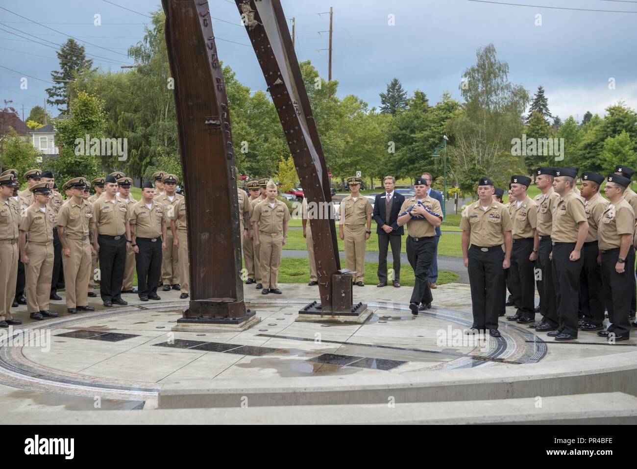 BREMERTON, Wash. (Sept. 11, 2018) Electronics Technician 1st Class James Mooneyham, a chief petty officer select, assigned to Unmanned Undersea Vehicle Squadron 1 (UUVRON 1), conducts morning colors during a 9/11 Remembrance Ceremony held at the Kitsap 9/11 Memorial. The ceremony, held by the 2019 DEVRON 5 Chief Petty Officer Selects, marks the 17th anniversary of the 9/11 attacks and honors those who lost their lives that day. Stock Photo