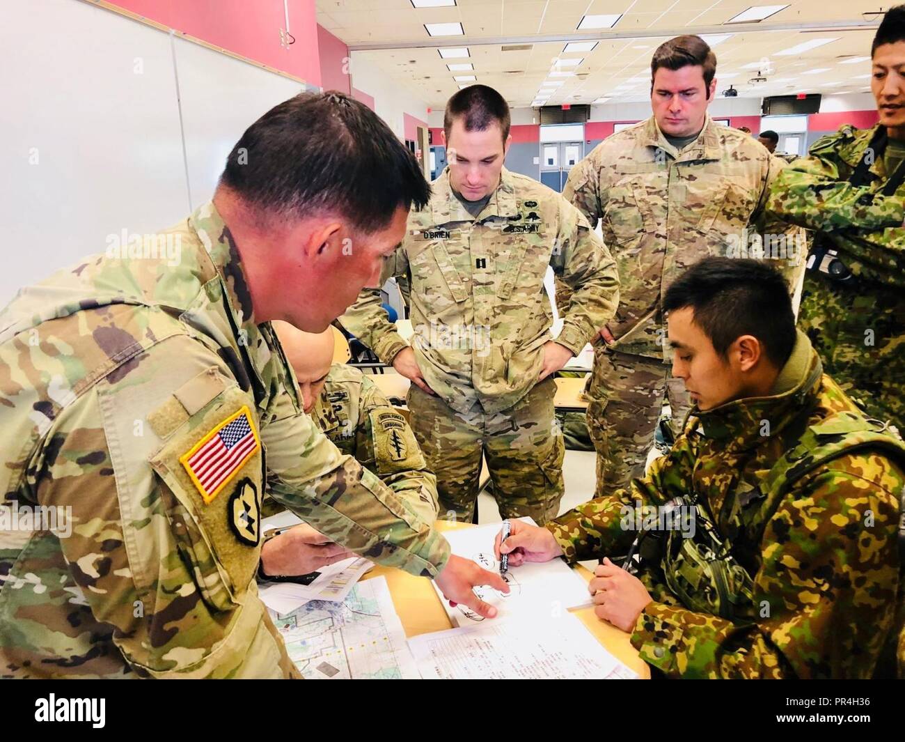 Staff Sgt Miller Provides A Translation For High Altitude Low Opening Parachute Jump Calculations To Japanese Free Fall Jump Masters Of The Japan Ground Self Defense Force Prior To A Jump At Eielson