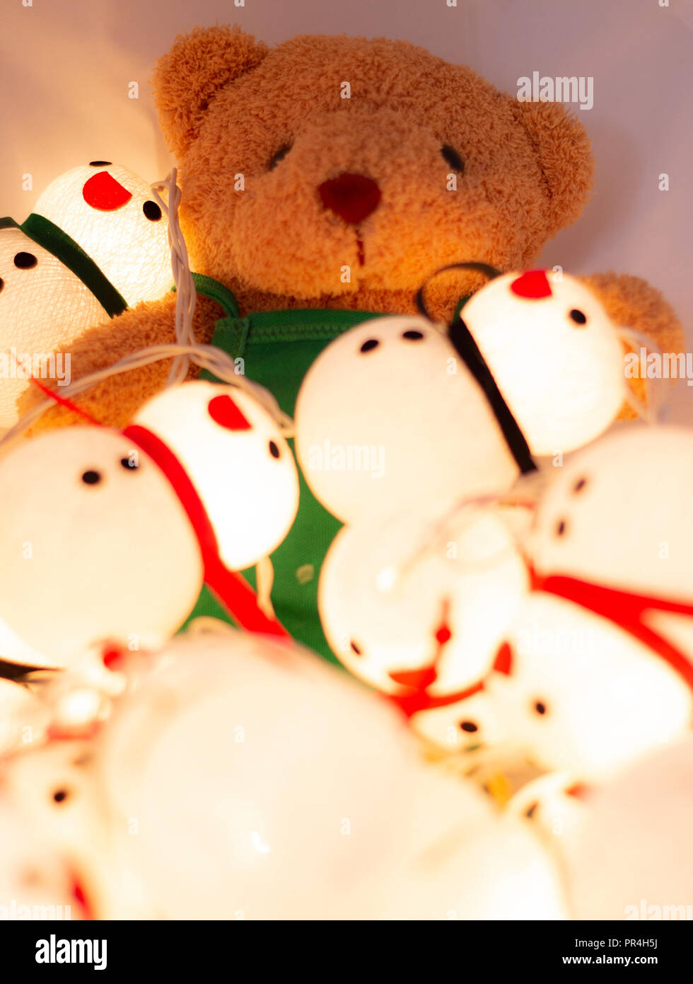 little doll bear and snow doll with the colorful light Stock Photo