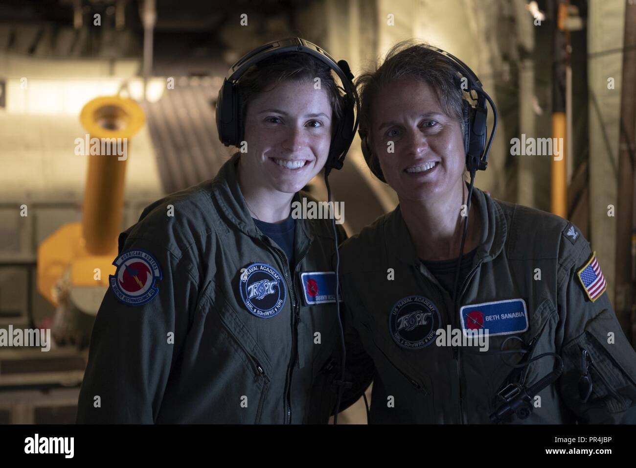 U.S. Navy Midshipman Shannon McAllister (left) and Captain Beth Sanabia are mission scientist's during a Hurricane Hunters mission that took off from the US Naval Academy   Savanah Air National Guard Base, Savanah, GA Airport, September 13, 2018. The U.S. Air Force Reserve 53rd Weather Reconnaissance Squadron, or Hurricane Hunters, is conducting a storm tasking mission into Hurricane Florence using a WC-130J Hercules, currently a category 2 storm. The flight tasking provides critical and timely weather data for the National Hurricane Center to assist in providing up-to-date and accurate inform Stock Photo
