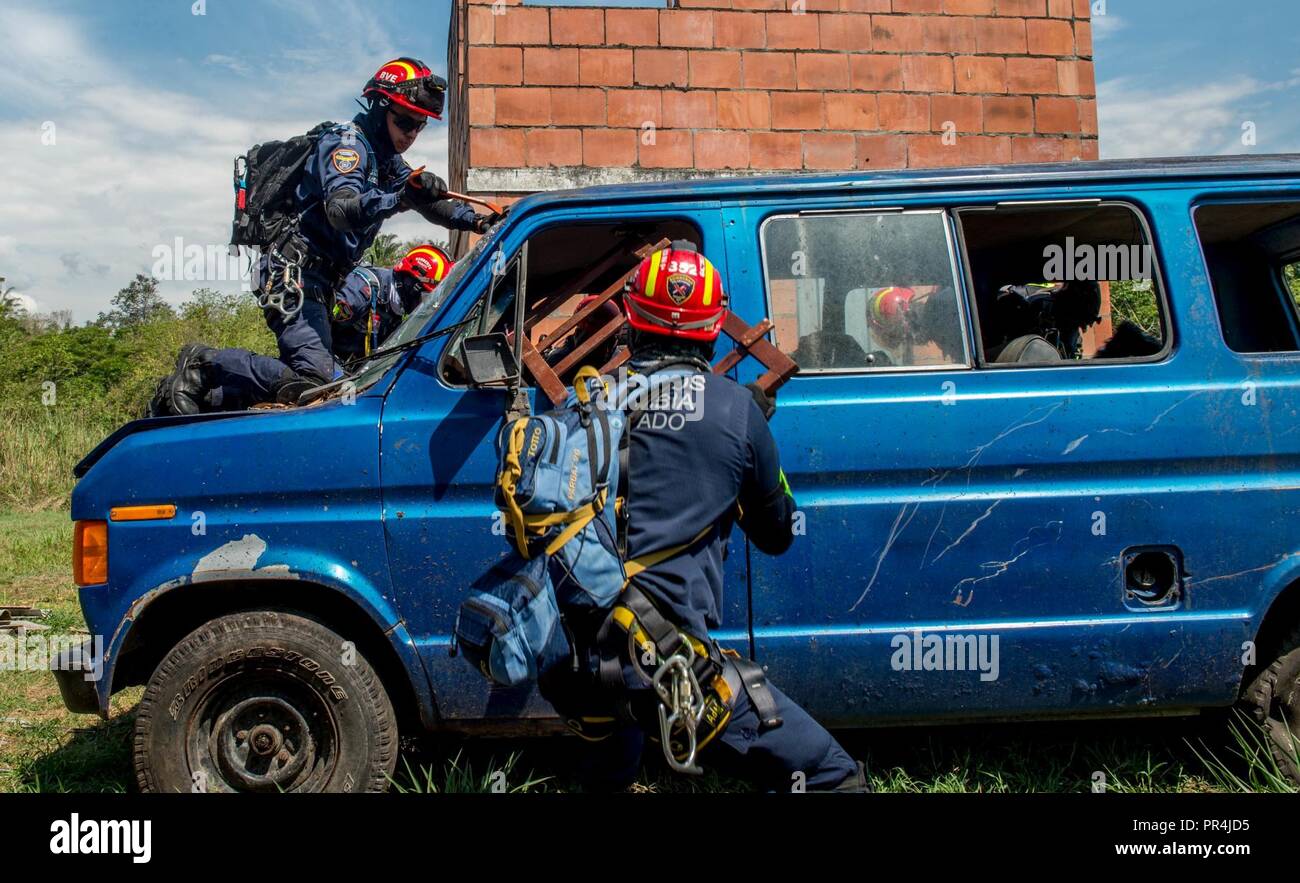 Colombian firefighters attempt to rescue a triage patient trapped in a vehicle during a mass casualty earthquake simulation as part of the multilateral exercise Angel de los Andes Sept. 6, 2018, at German Olano Air Base, Colombia. The first week of the exercise is focused on responding to natural disaster scenarios that include an earthquake response, a forest fire and an open water rescue, as well as responding to an aircraft crash. Stock Photo