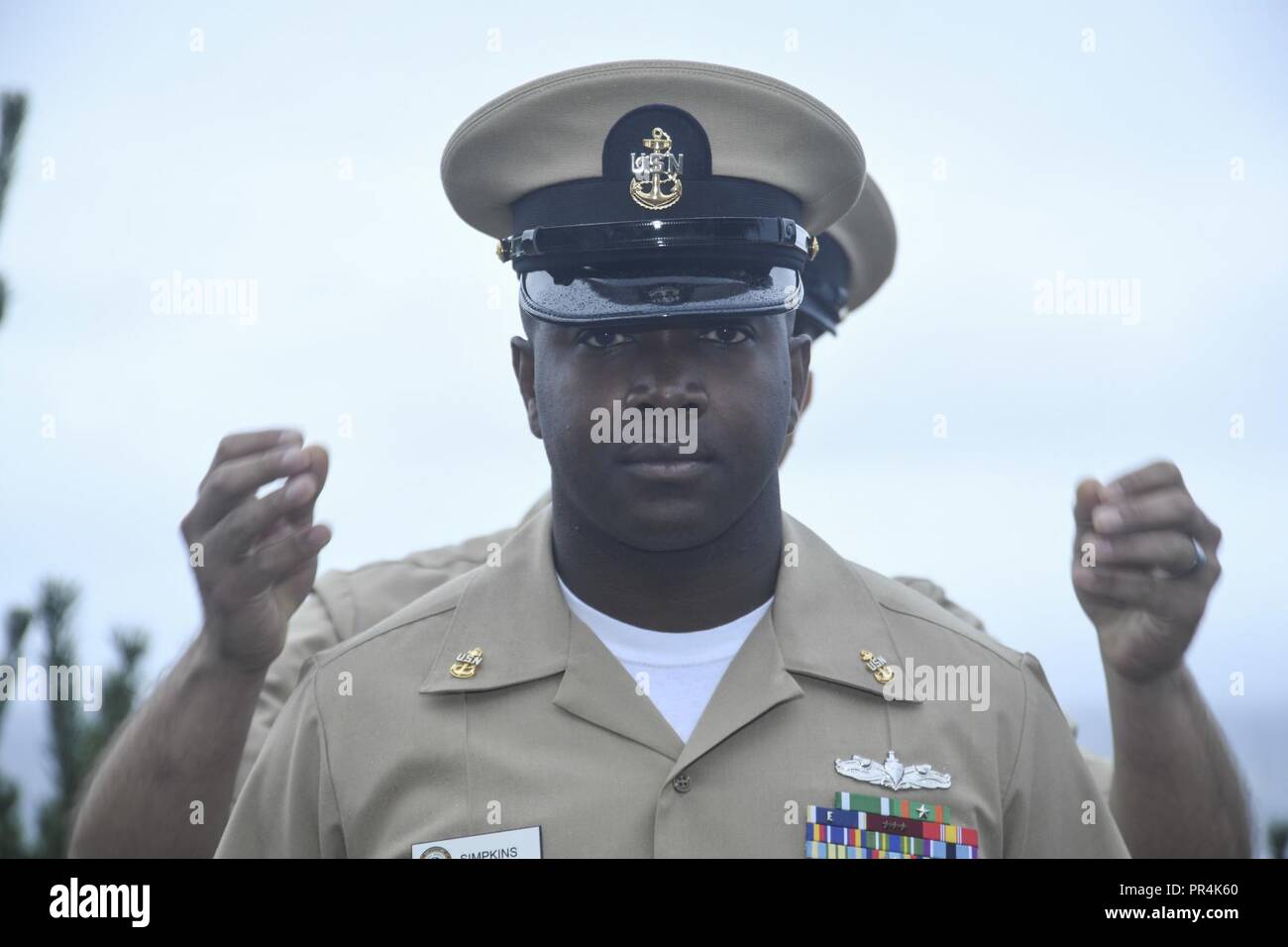 Wash. (Sept. 14, 2018) - Chief Culinary Specialist Donald Simpkins, a native of Montgomery, Ala., has his chief petty officer (CPO) cover placed upon his head by Senior Chief Hospital Corpsman Brian Nielson during Naval Hospital Bremerton's (NHB) CPO pinning ceremony. During the ceremony, five Sailors from BNH received their anchors. Stock Photo