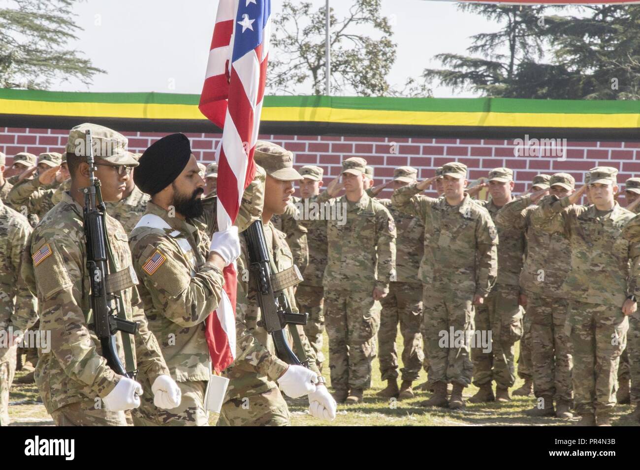 Sgt. Gurpreet Gill, a U.S. Soldier with 1-2 Stryker Brigade Combat Team, marches with the national colors onto a parade field, during the Yudh Abhyas 18 opening ceremony at the Chaubattia Military Station in Ranikhet, India, Sept. 16, 2018. Gill, who was originally from India, acted as a cultural advisor for U.S. Soldiers during Yudh Abhyas. The bilateral training exercise geared toward enhancing cooperation and coordination between the U.S. and Indian armies through professional development and cultural exchanges. Stock Photo