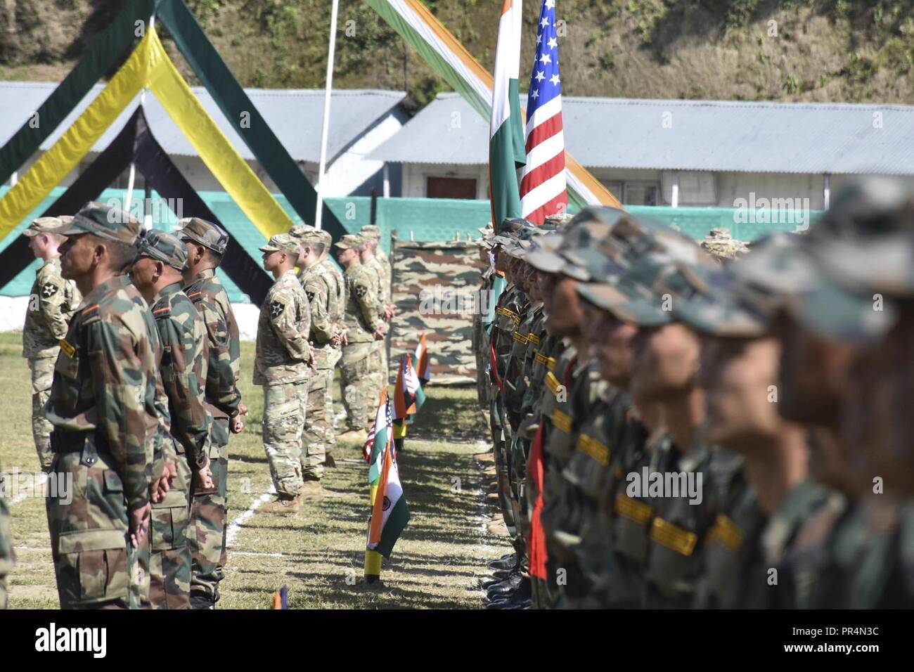 Soldiers with the Indian and U.S. armies listen to remarks at Chaubattia Military Station in Ranikhet, India, Sept. 16, 2018, during the opening ceremony of Yudh Abhyas 18. The bilateral training exercise geared toward enhancing cooperation and coordination between the two nations’ armies through training and cultural exchanges. Stock Photo