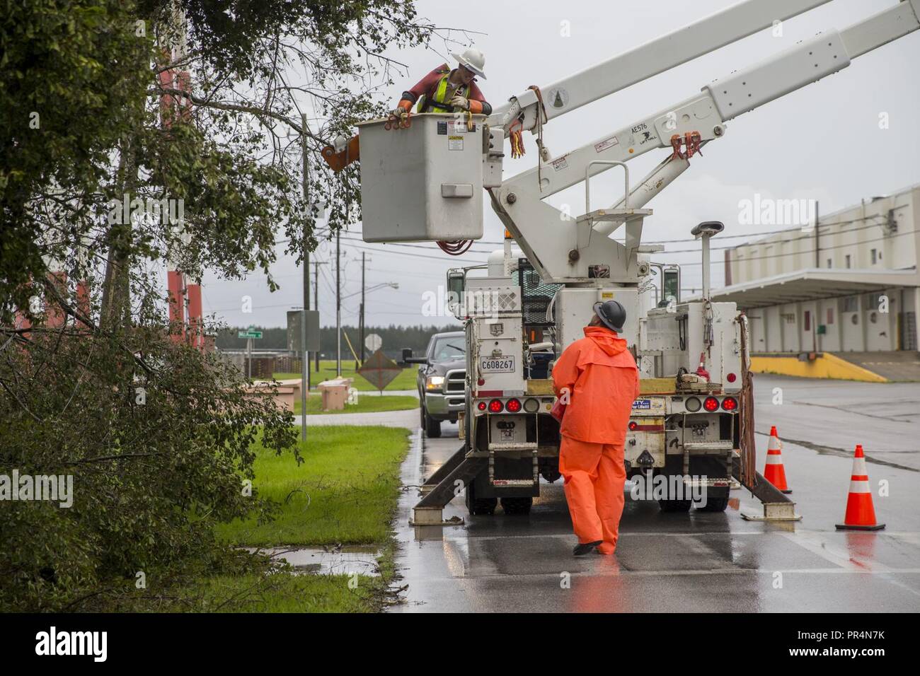 Utility workers with JCL Power Boyce L.A., repair damaged power lines ...