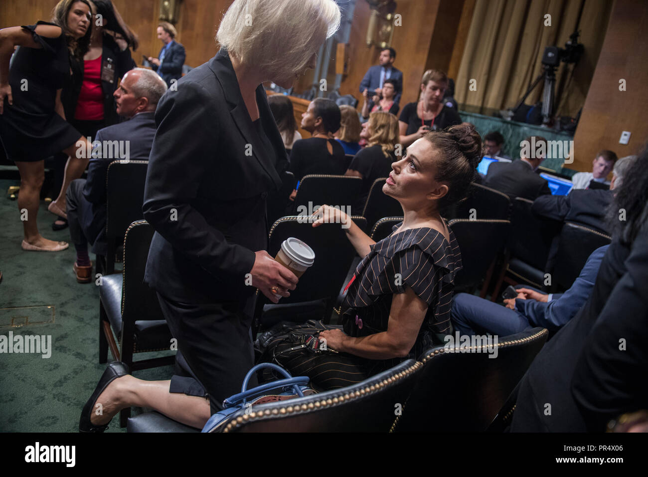 UNITED STATES - SEPTEMBER 27: Actress Alyssa Milano, right, talks with Sen. Kirsten Gillibrand, D-N.Y., in the hearing room before the start of Dr. Christine Blasey Ford's appearance in the Senate Judiciary Committee to testify on the nomination of Brett M. Kavanaugh to be an associate justice of the Supreme Court of the United States. (Photo By Tom Williams/CQ Roll Call) | usage worldwide Stock Photo