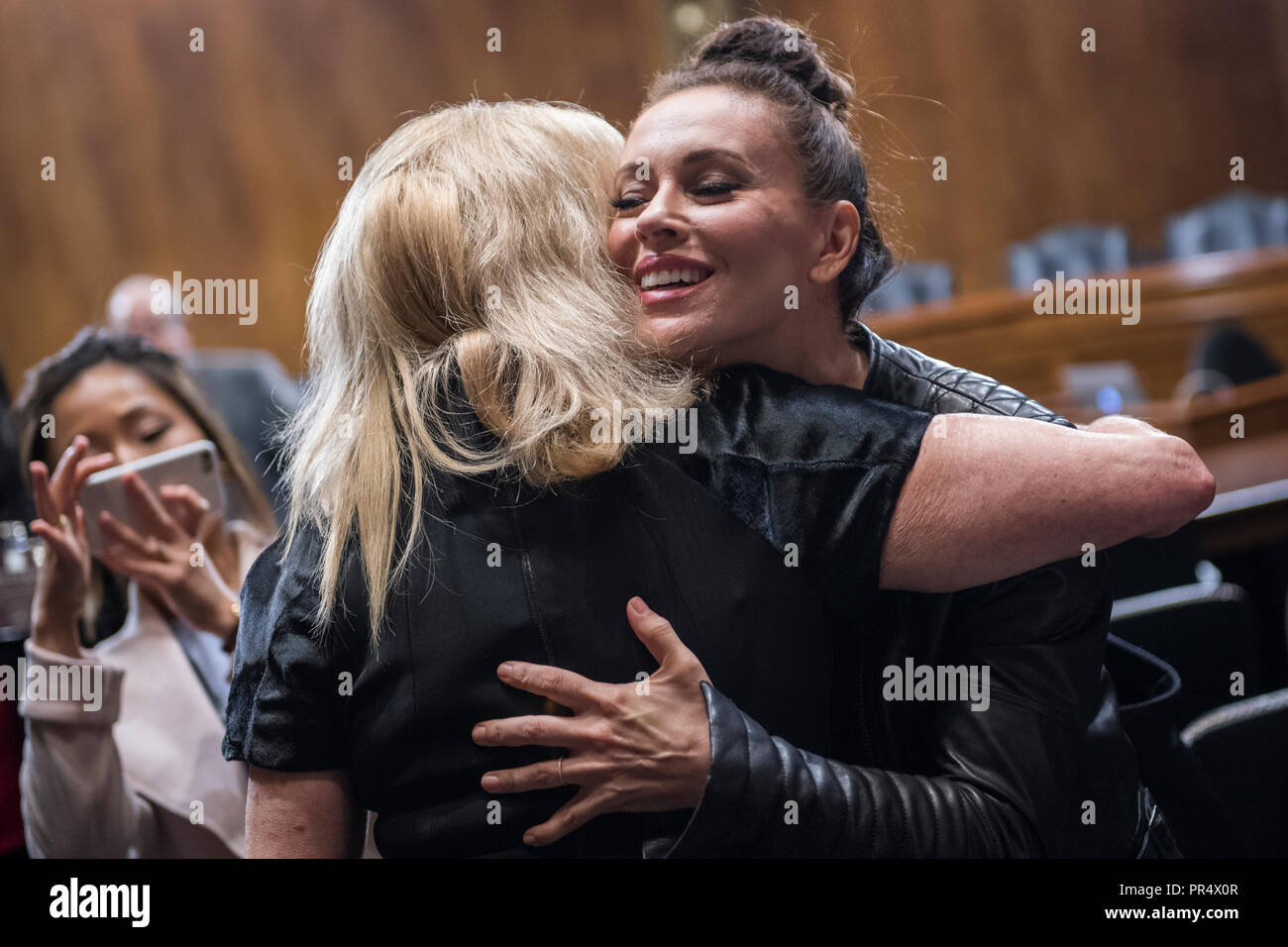 UNITED STATES - SEPTEMBER 27: Actress Alyssa Milano, right, hugs Rep. Carolyn Maloney, D-N.Y., in the hearing room before the start of Dr. Christine Blasey Ford's appearance in the Senate Judiciary Committee to testify on the nomination of Brett M. Kavanaugh to be an associate justice of the Supreme Court of the United States. (Photo By Tom Williams/CQ Roll Call) | usage worldwide Stock Photo