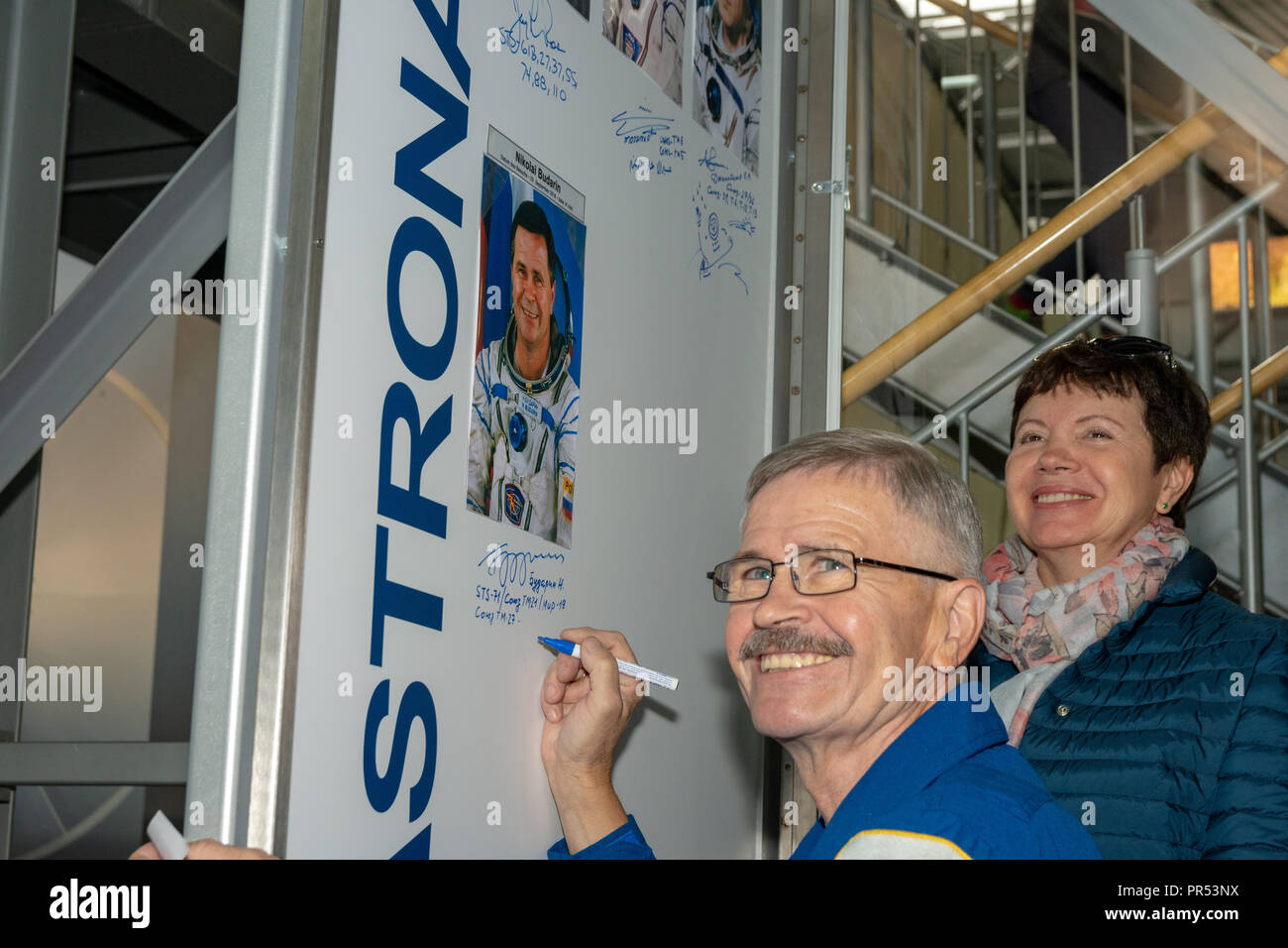 Speyer, Germany. 29th Sept 2018.  Cosmonaut Nikolai Budarin signing his exhibit during his visit at Technik Museum Speyer, Germany. With his wife (right) Credit: Markus Wissmann/Alamy Live News Stock Photo