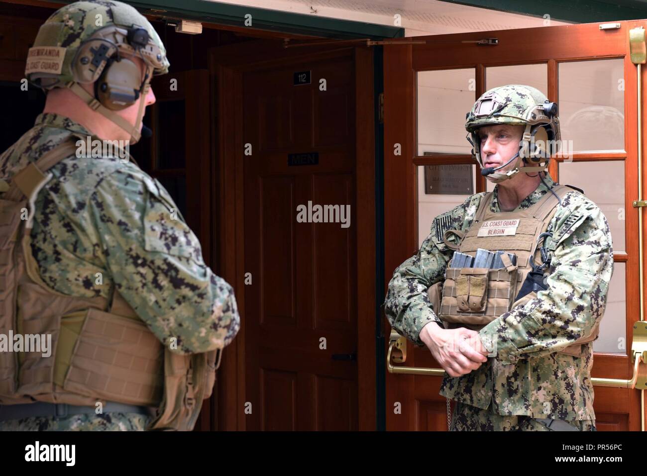 Coast Guard Port Security Unit 313 crewmembers stand outside Legion