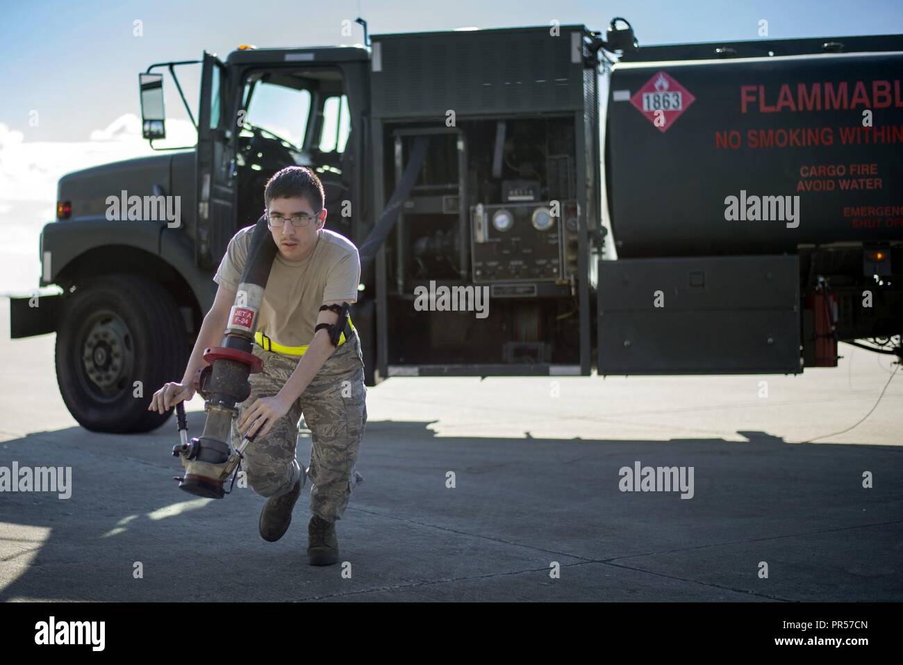 A 6th Logistics Readiness Squadron Airman tows a fuel hose during an operational readiness exercise at MacDill Air Force Base, Florida, Sept. 12, 2018. During the three-day event, the 6th Air Mobility Wing and 927th Air Refueling Wing practiced their alert response time to maintain readiness. Stock Photo