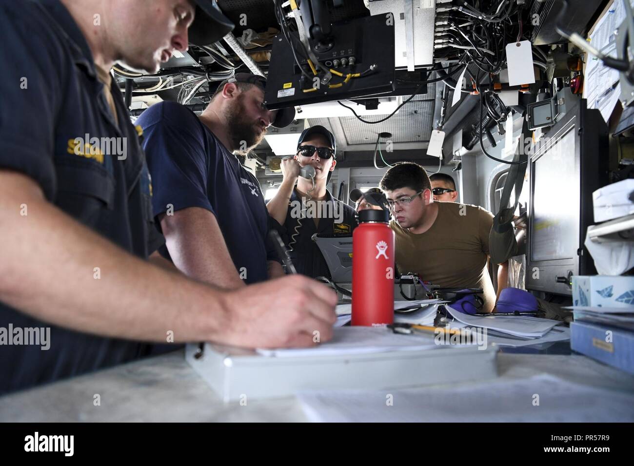 ARABIAN GULF (Sept. 16, 2018) Sailors receive training on the bridge of coastal patrol ship USS Thunderbolt (PC 12) prior to a MK-60 Griffin guided missile system shoot. Ships attached to U.S. 5th Fleet's Task Force 55 are conducting Griffin surface-to-surface missile and naval gun exercises against high speed maneuvering targets to advance their ability to defend minesweepers and other coastal patrol ships. U.S. 5th Fleet and coalition assets are participating in numerous exercises as part of the greater Theater Counter Mine and Maritime Security Exercise to ensure maritime stability and secu Stock Photo