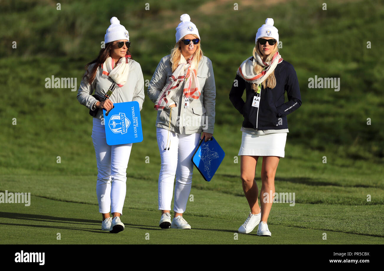 Katie Poulter, wife of Ian Poulter (centre) and Kelley Cahill (right), girlfriend of Jon Rahm during the Fourballs match on day two of the Ryder Cup at Le Golf National, Saint-Quentin-en-Yvelines, Paris. Stock Photo