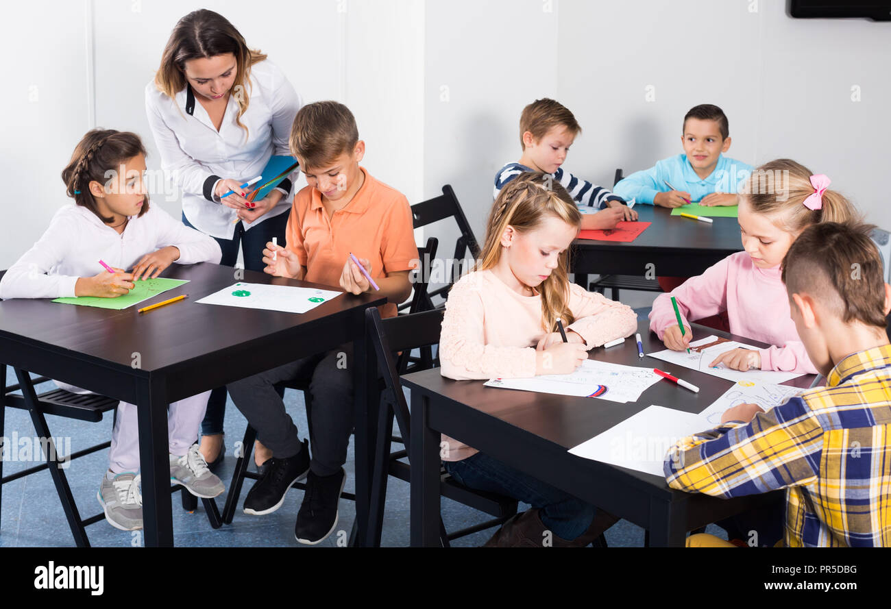 Group of children in elementary age drawing together at classroom Stock ...