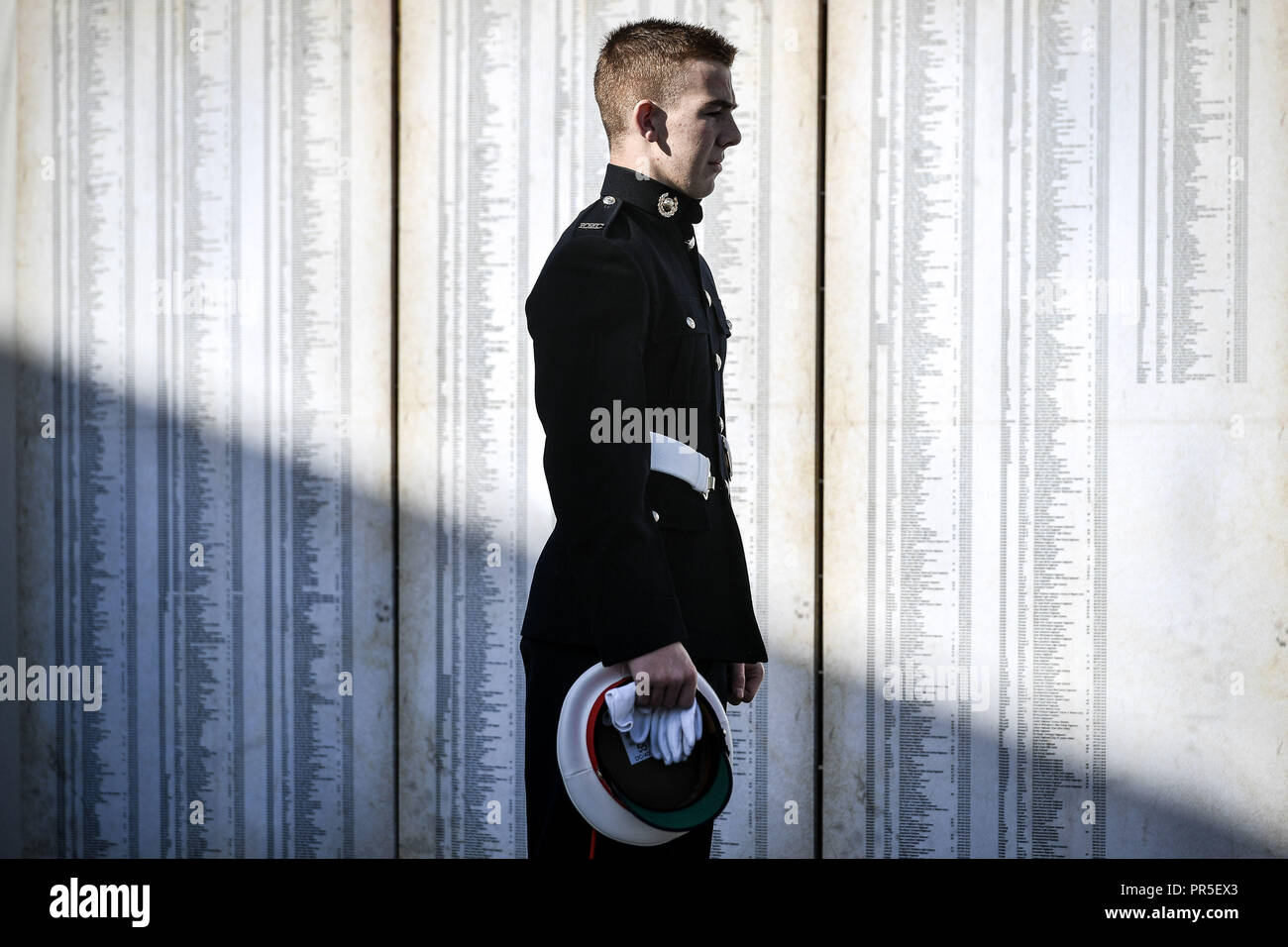 A Royal Marine cadet stands in front of just some of 72,396 names representing Commonwealth servicemen killed at the Somme, which is part of the Shrouds of the Somme artwork by artist Robert Heard, at Aerospace Bristol. The exhibition, featuring a 45 metre trench lined with thousands of hand-stitched calico shrouded figures, each measuring 12 inches long, runs until 14th October at the South Gloucestershire site before heading to London's Queen Elizabeth Olympic Park between 8 - 18 November. Stock Photo