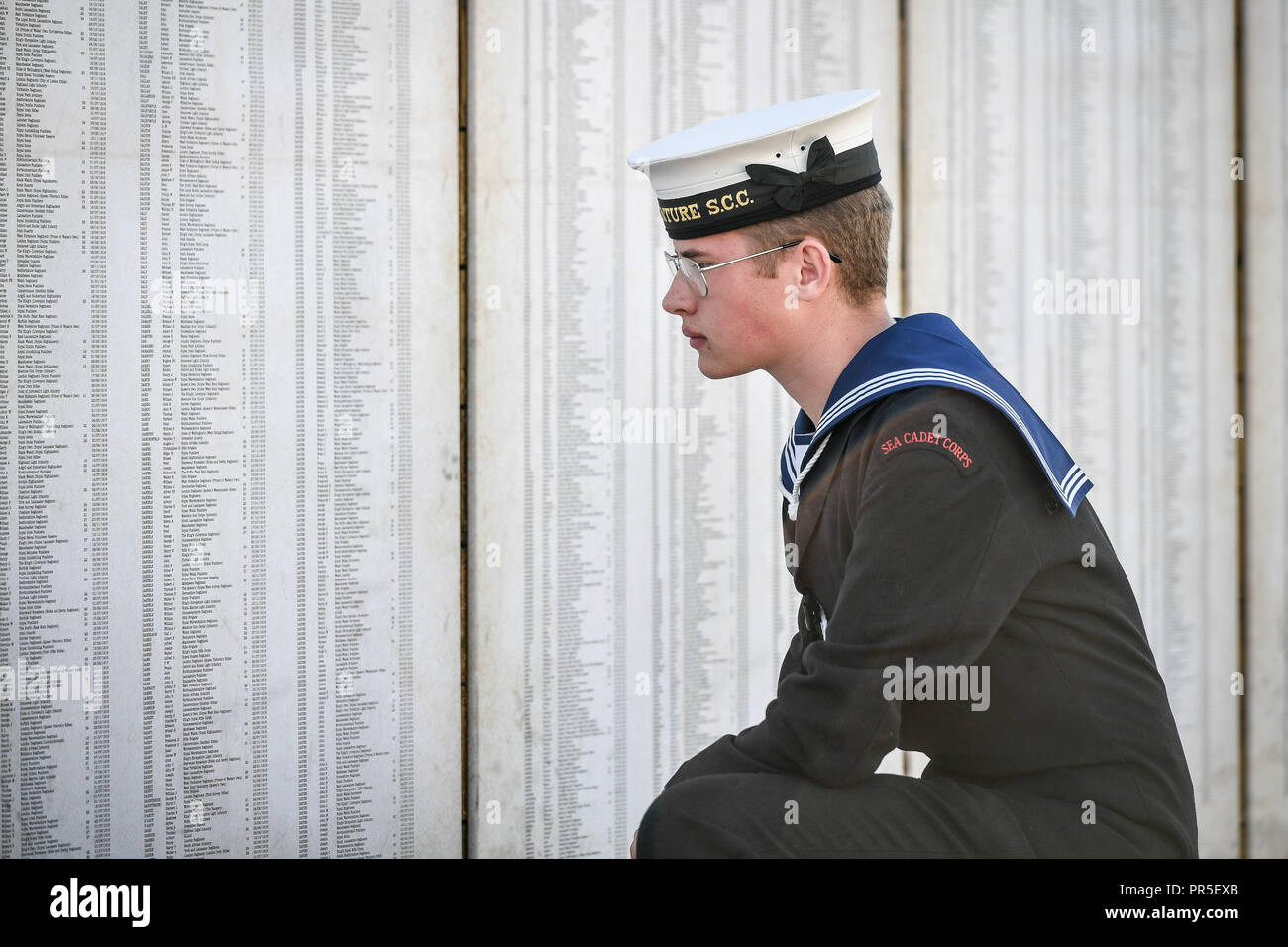 Sea cadet Jack Pacemen, 15, reads some of the 72,396 names representing Commonwealth servicemen killed at the Somme, which is part of the Shrouds of the Somme artwork by artist Robert Heard, at Aerospace Bristol. The exhibition, featuring a 45 metre trench lined with thousands of hand-stitched calico shrouded figures, each measuring 12 inches long, runs until 14th October at the South Gloucestershire site before heading to London's Queen Elizabeth Olympic Park between 8 - 18 November. Stock Photo