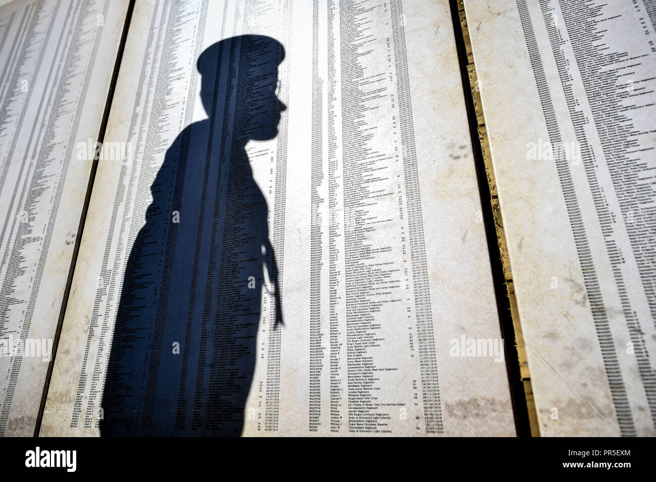 A sea cadet casts a shadow on just some of 72,396 names representing Commonwealth servicemen killed at the Somme, which is part of the Shrouds of the Somme artwork by artist Robert Heard, at Aerospace Bristol. The exhibition, featuring a 45 metre trench lined with thousands of hand-stitched calico shrouded figures, each measuring 12 inches long, runs until 14th October at the South Gloucestershire site before heading to London's Queen Elizabeth Olympic Park between 8 - 18 November. Stock Photo