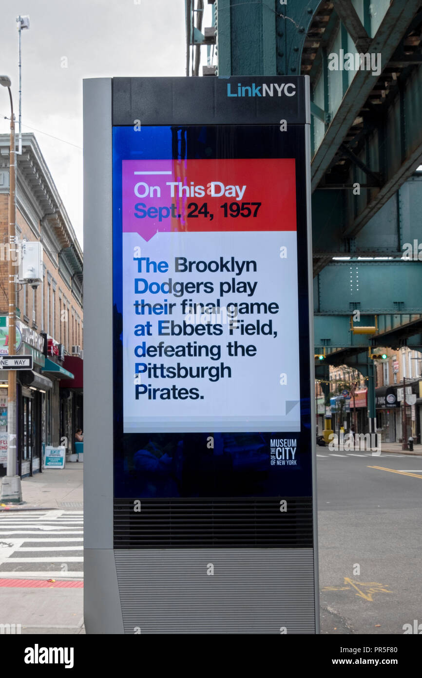 A message on a LINK NYC screen commemorating the 61st anniversary of the Brooklyn Dodgers last game at Ebbets Field in Brooklyn. In Queens, NYC Stock Photo
