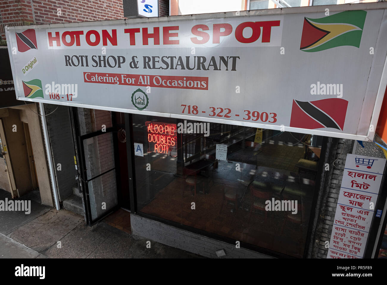 The exterior of HOT ON THE SPOT Roti Shop & Restaurant  on Liberty Ave. in South Richmond Hill, Queens, New York City. Stock Photo
