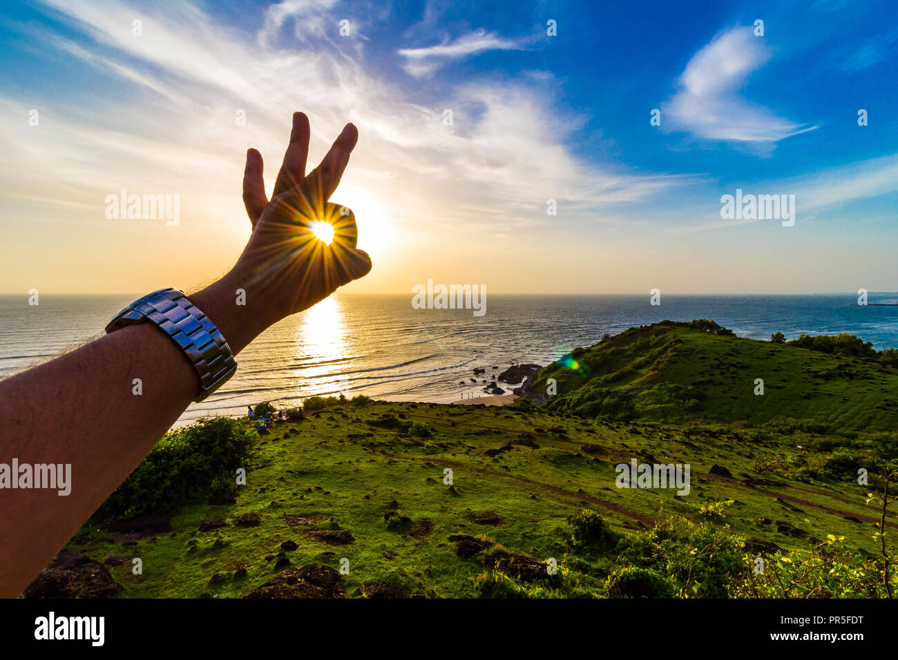 Vagator Beach - Sunset rays captured in the frame around the green natural  beauty of Goa, India Stock Photo - Alamy