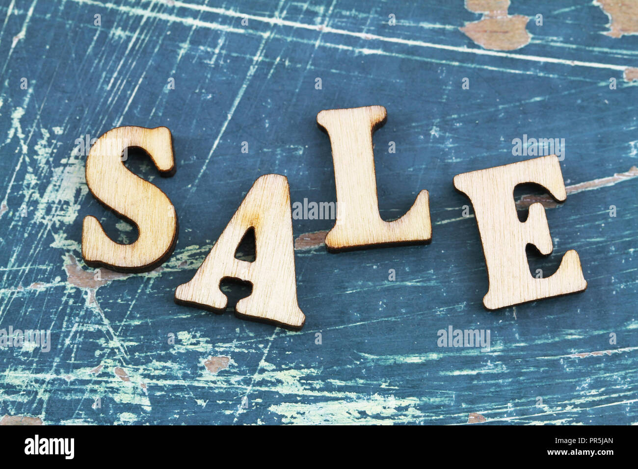 Word sale written with wooden letters on rustic surface Stock Photo