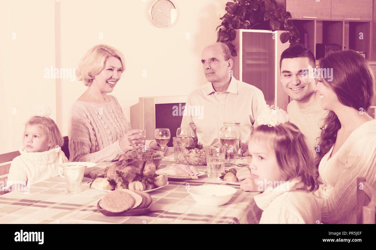 Portrait of smiling big family at the dining table indoor Stock Photo ...