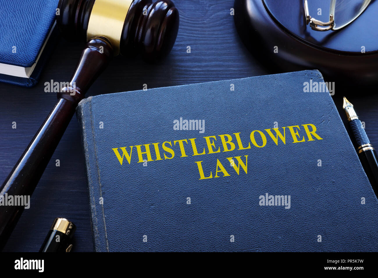Whistleblower law book and gavel in a court. Stock Photo