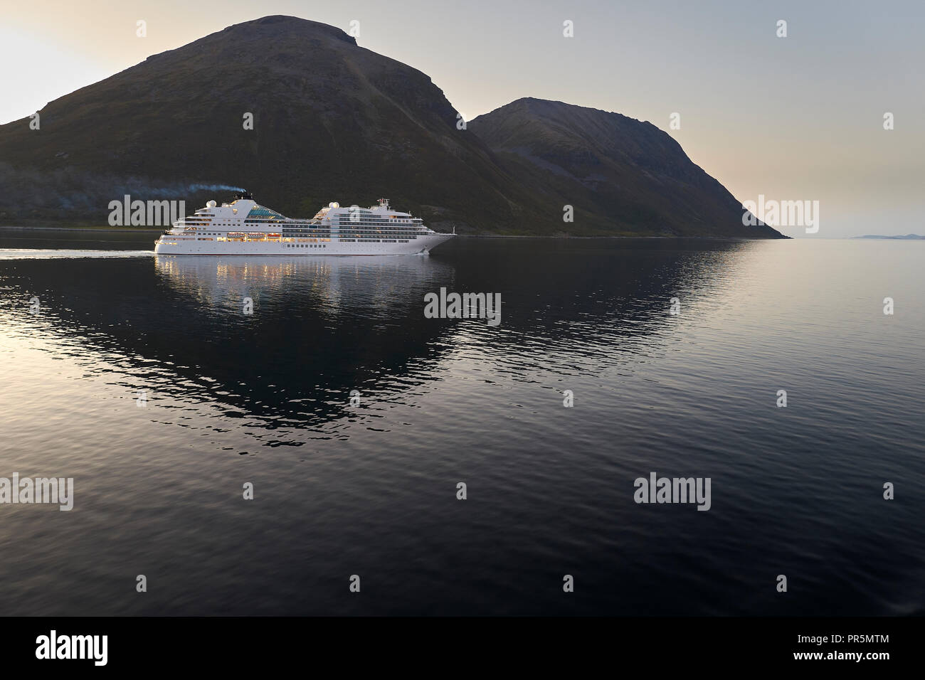 The Cruise Ship, Seabourn Ovation, Sails Through The Lauksundet, Close To Skjervøy, Far North Of The Norwegian Arctic Circle During The Midnight Sun. Stock Photo