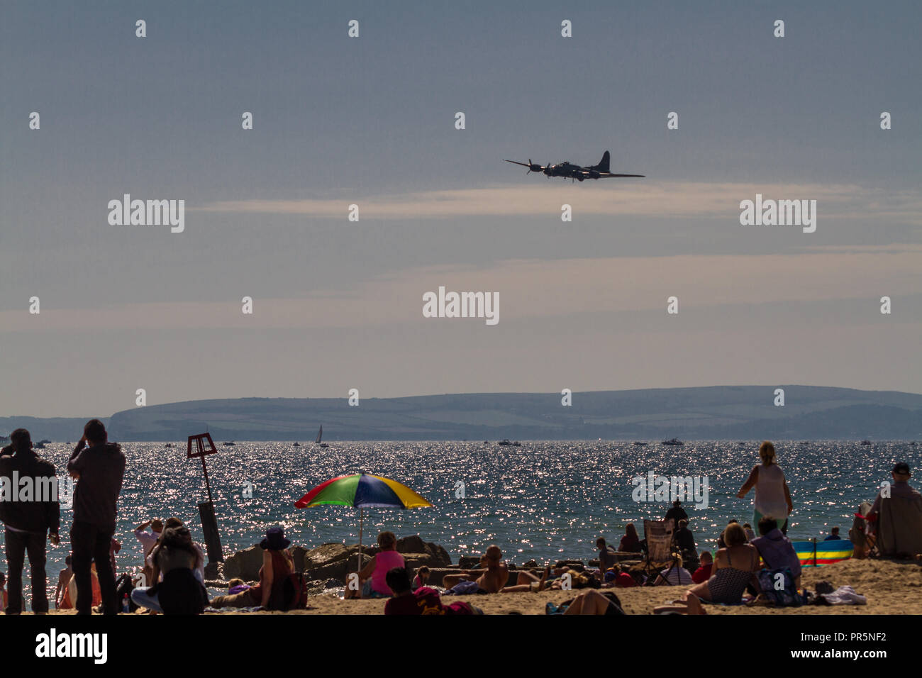 Bournemouth, United Kingdom – Bournemouth Air Festival 2018 spectators on beach Sally-B B17 Flying Fortress aeroplane on September 2 2018 in Bournemou Stock Photo