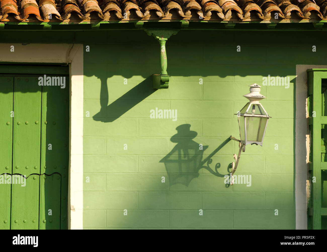 creative lights and shadows on green painted facade in Trinidad Cuba Stock Photo