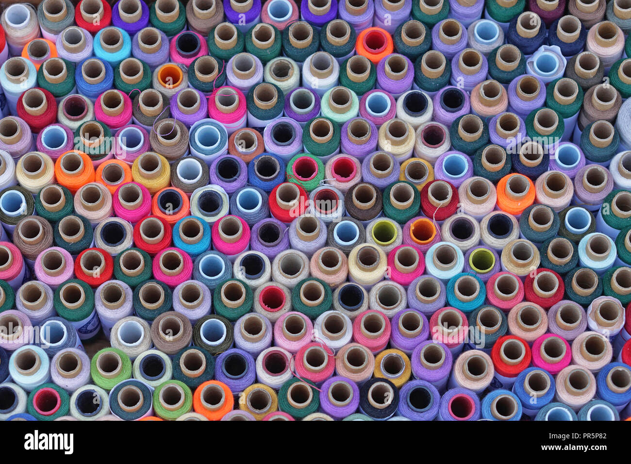 Colorful sewing threads and yarns background Stock Photo - Alamy