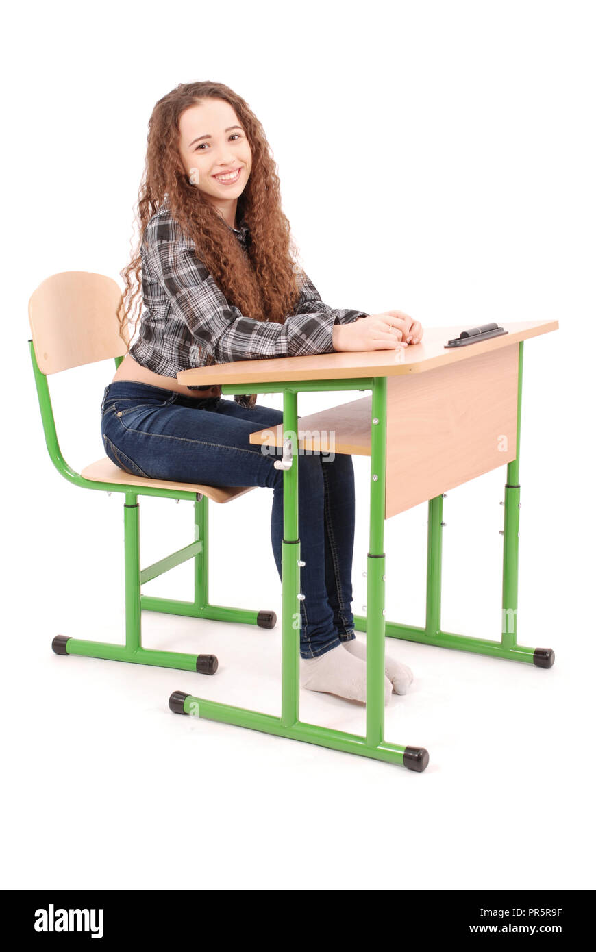 School girl sitting at a desk isolated on white Stock Photo - Alamy