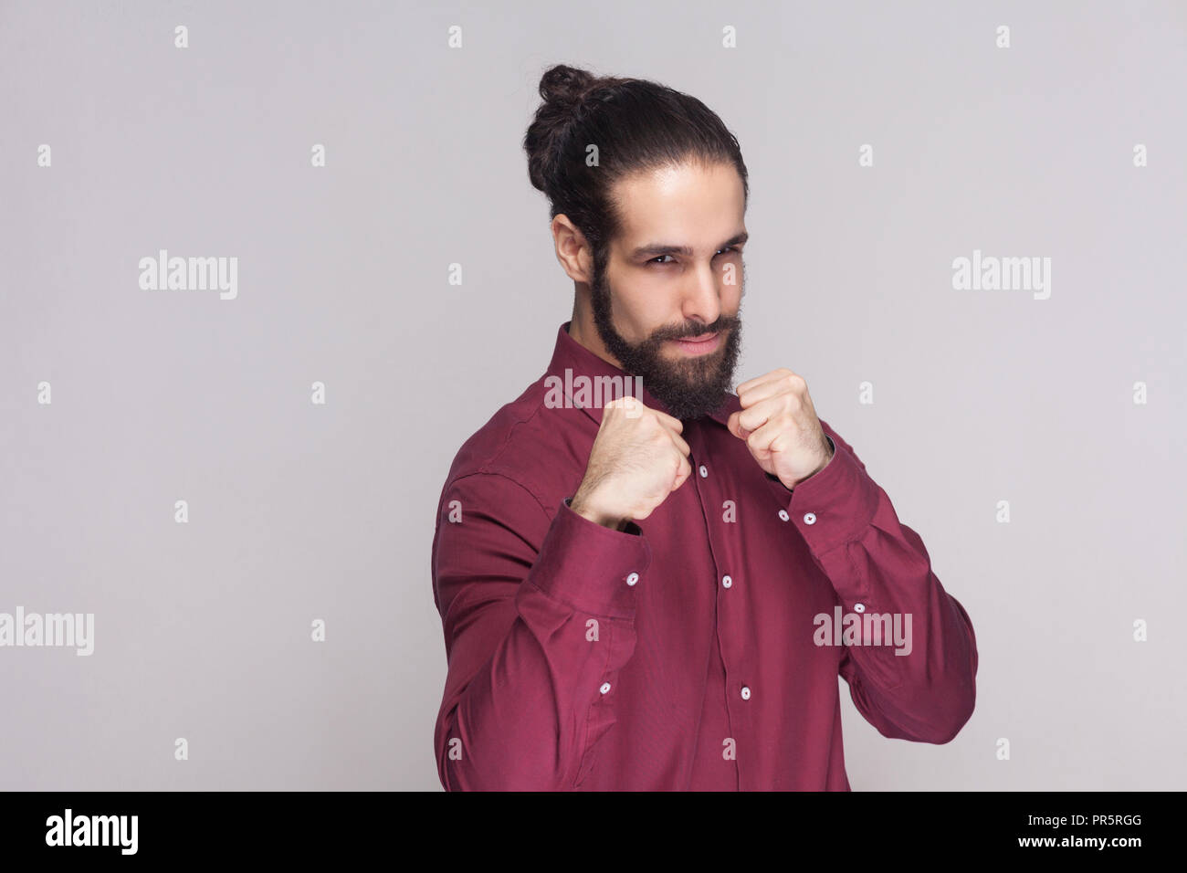 Portrait Of Serious Handsome Man With Dark Collected Long Hair And